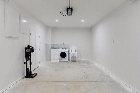 The washing machine and vacuum are located in the garage.