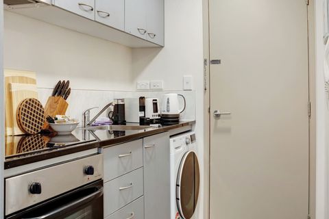 The combo washing machine and dryer is located in the kitchen area.