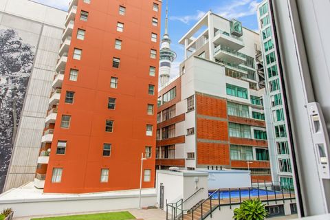 The view from the apartment overlooking the courtyard and swimming pool. You can see the Sky Tower between the buildings.