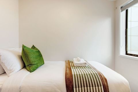 The white sheets invite you to rest and relax in this comfy bed.