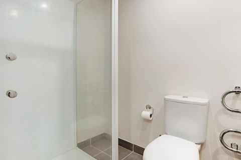 The main bathroom has a toilet, vanity and shower.