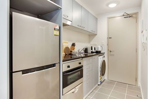 The kitchen has a cook top, oven, dishwasher, fridge/freezer and microwave.