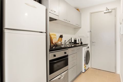 The kitchen has a cook top, oven, dishwasher, fridge/freezer and microwave.