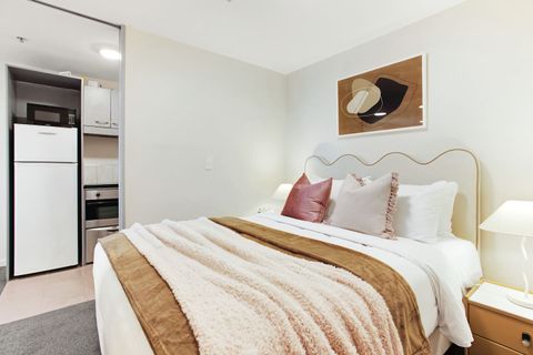 This bedroom is located off the main living space and has a glass window that lets in the light.