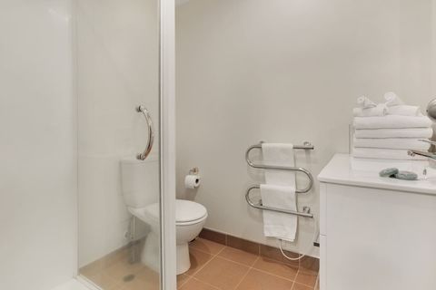 The main bathroom has a toilet, vanity and shower.