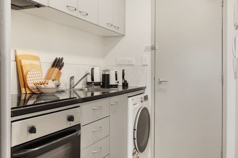 The combo washing machine and dryer is located in the kitchen area.