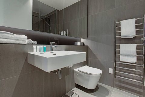 The ensuite bathroom has a shower, toilet and basin plus lots of storage in the mirrored cupboards.