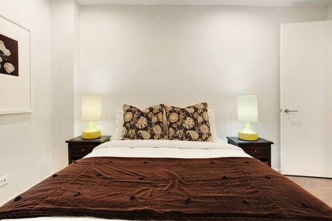 The Queen bed looks inviting and comfortable with the colours of nature.