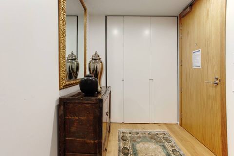 The hallway entrance into the apartment is complete with artwork and decorations.