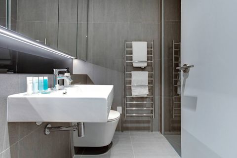 The shower is glass enclosed in a modern style.