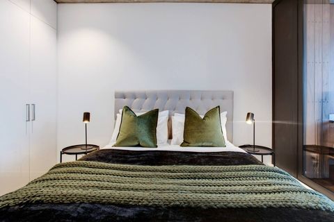 The bedroom looks cosy with its shades of relaxing green.