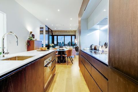 The kitchen has an oven, cooktop, microwave, dishwasher and fridge/freezer.