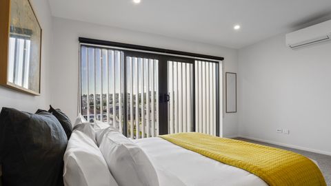 This bedroom has both air-conditioning and a ranch slider to open.