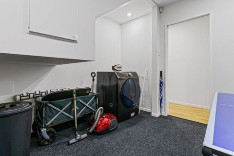 The dryer is located in the garage area.