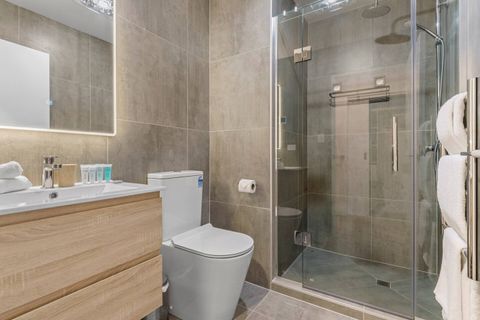 The ensuite bathroom has a vanity with drawers for storage, toilet and shower.