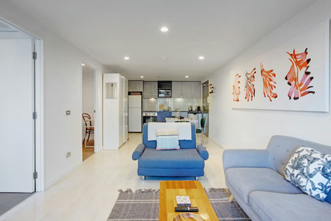 View of the apartment with the living room, dining area and kitchen.