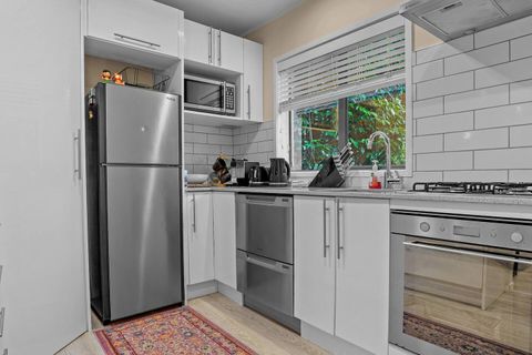 The kitchen has an oven, cooktop, microwave, dishwasher and fridge/freezer.