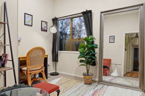 The full-length mirror reflects the light in the room.