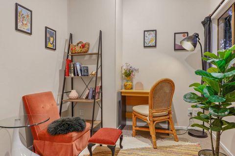 There is a handy office with desk, chairs and book shelfs.