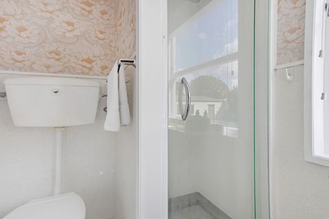 The ensuite also has a shower box and toilet.