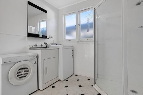 In the laundry, there is a washing machine and dryer, plus an extra shower.