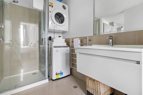 The washing machine and dryer are conveniently located in the bathroom.