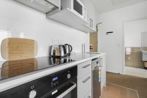 The kitchen has a glass cooktop and oven, which are great for cooking meals.