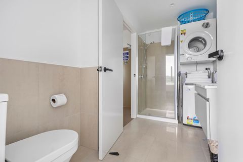 The bathroom is a modern space with shower, vanity and toilet.