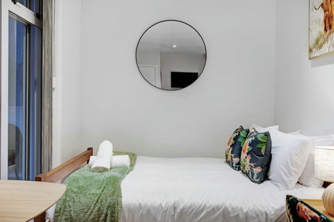 The bed is tucked into the corner to give you more space in the apartment.