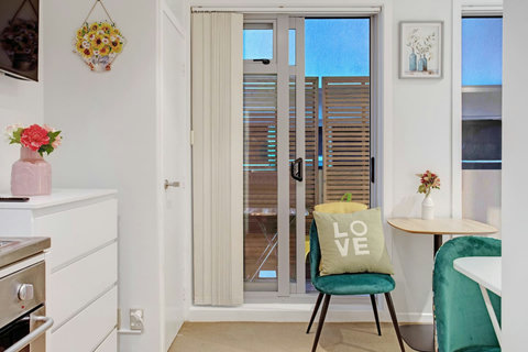The dining table has enough room for two people to be able to eat together.