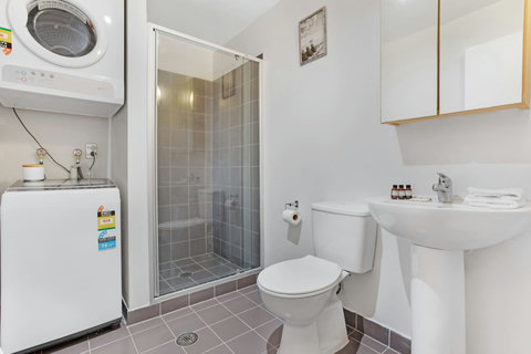 The bathroom has the washer and dryer handily located for ease of use.