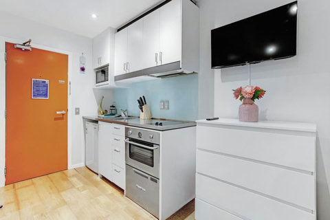 The TV is wall-mounted, freeing up floor space.