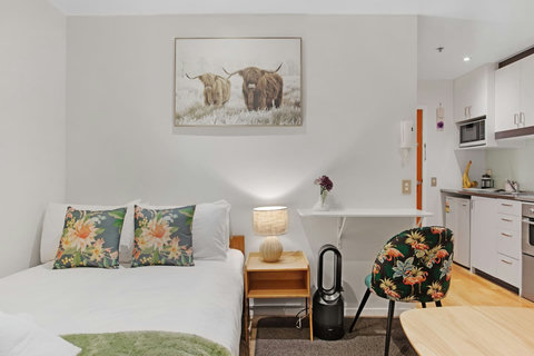 There is a handy wall table that can be used for a laptop.