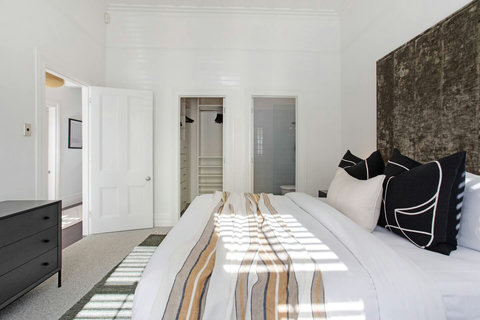 This bedroom has a King-sized bed with ensuite bathroom and walk-in wardrobe.