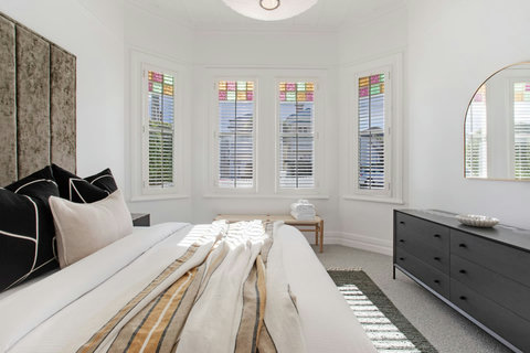 There are original features scattered throughout the home, including leadlight glass and high ceilings.