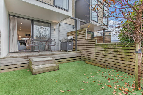 The backyard is fully fenced with low maintenance artificial grass.