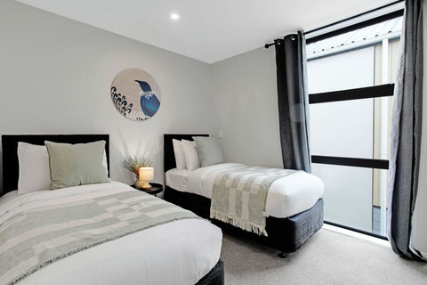 The bed looks inviting with its crisp white sheets and fluffy throw.