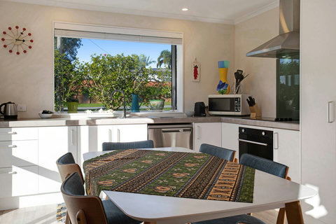 The kitchen has a microwave, dishwasher, oven, cooktop and fridge/freezer.