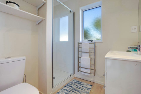 There is a shower, vanity and toilet in the bathroom.