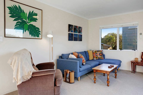 The living room has a comfy couch and chair so you can relax in your space.