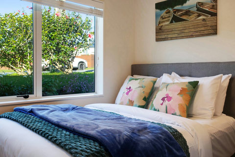 The flower cushions match the throw and brings the outside in.