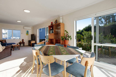 The dining table is located in the open-plan living spaces that include the kitchen and lounge.