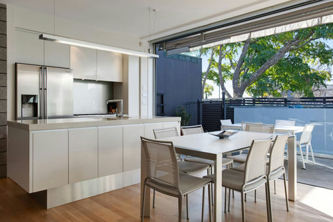 The kitchen and dining room are modern with clean lines.