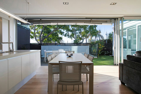 The kitchen and dining area are part of the open-plan living and indoor/outdoor flow.