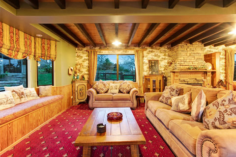 The lounge has plenty of seating and comes out of an overseas ranch style home.