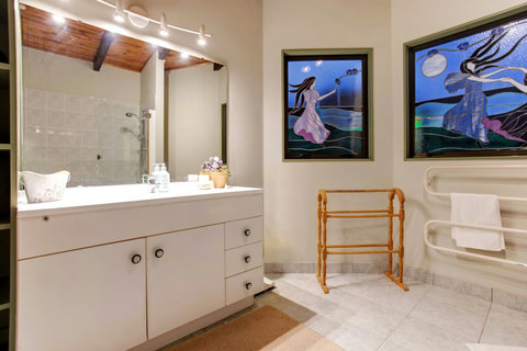 The ensuite bathroom has lovely stained glass windows.