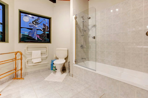 The ensuite has both a bath and a shower over bath, vanity unit and toilet.