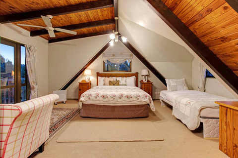 The main upstairs bedroom makes the best use of space with both a King and a King-single in the room.