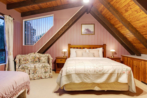 Enjoy the little love seat in the bedroom, perfect for reading a book.