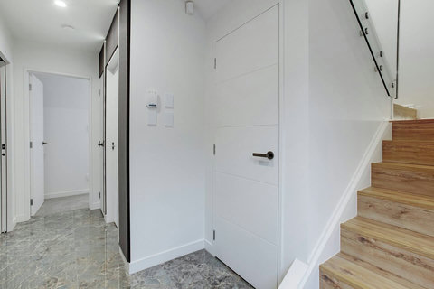 The stairs from level 2 to level 1 with the lift beside.